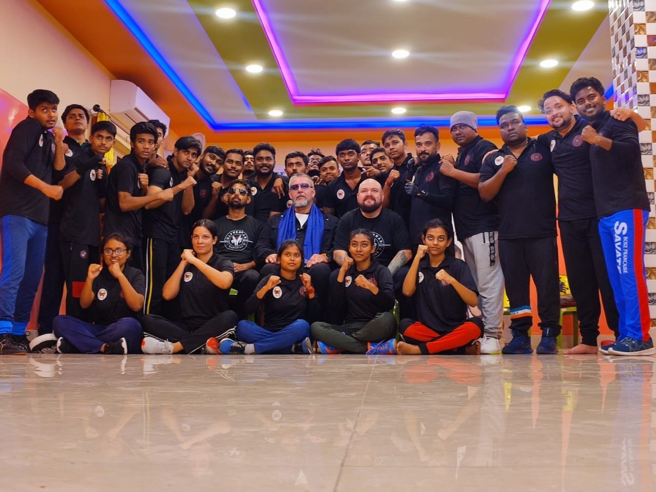 Richard with his Jeet Kune Do students in India — the full seminar group, fists up