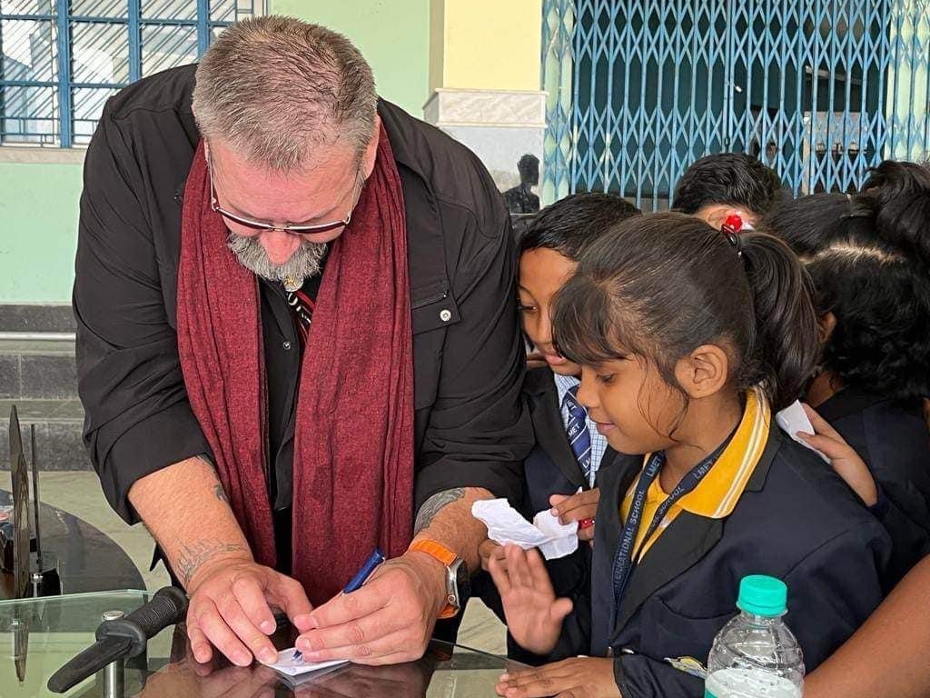 Richard signing autographs for schoolchildren in India